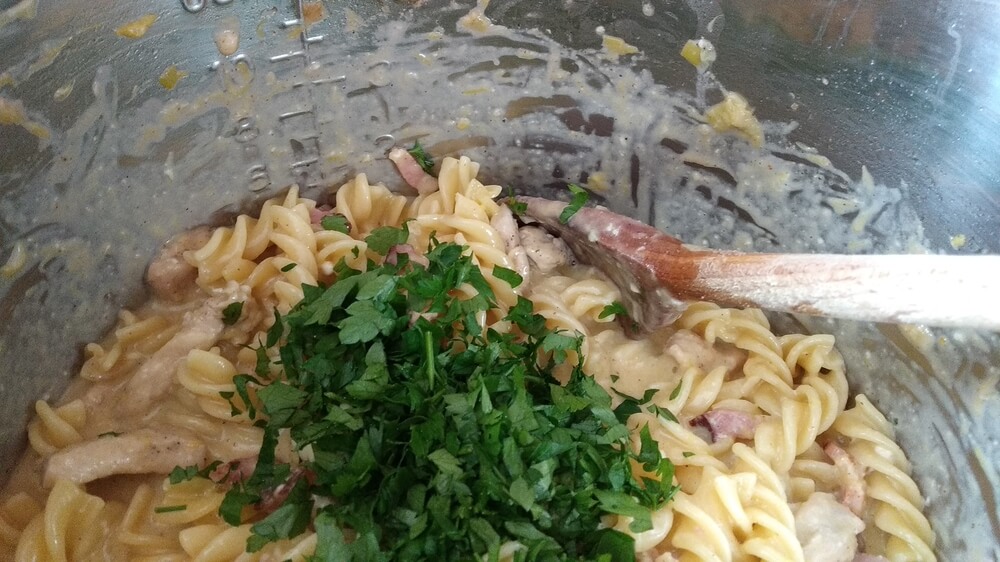 chopped parsley added to cheesy pasta inside instant pot