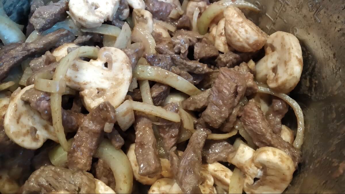 meat and vegetables inside instant pot - stroganoff