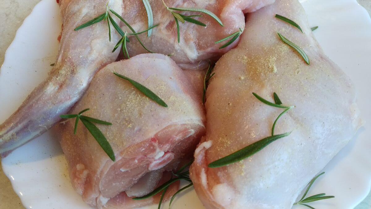 chopped rabbit meat with herbs and spices on a plate