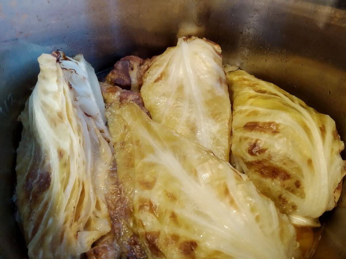 cooked pork neck under cabbage inside instant pot